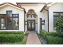 Elegant home entrance featuring a brick walkway and ornate double doors at 1010 N Pennsylvania Ave, Winter Park, FL 32789