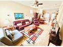 Spacious living room featuring comfortable seating, a coffee table, and a view of the dining area at 14650 Sweet Acacia Dr, Orlando, FL 32828