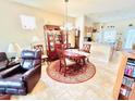 Bright dining room with a wooden table, chairs, and access to the kitchen at 14650 Sweet Acacia Dr, Orlando, FL 32828
