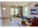 Bright and airy home office with built-in shelving and a view of the backyard at 15076 Grove Lake Dr, Winter Garden, FL 34787