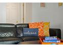 Comfortable living room with black leather couch and colorful pillows at 2601 Isla Vista Ct, Kissimmee, FL 34747