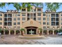 Luxury condo building with attractive landscaping and fountain at 501 Mirasol Cir # 213, Celebration, FL 34747