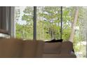 Bright living room with large windows and wooded view at 696 Preston Cove Dr, Saint Cloud, FL 34771