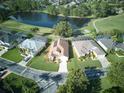 Community overview featuring homes with solar panels near a lake at 1102 Golf Course Pkwy, Davenport, FL 33837