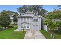 Two-story house with gray siding, a two-car garage, and a landscaped front yard at 1820 Blaine Ter, Winter Park, FL 32792