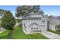 Two-story house with gray siding, a two-car garage, and a well-manicured lawn at 1820 Blaine Ter, Winter Park, FL 32792