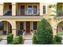 Townhome's front entrance with porch and well-manicured landscaping at 2321 Lobelia Dr, Lake Mary, FL 32746