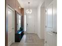 Bright and spacious entryway with modern wood wall and mirror at 5937 High Seas Dr, Orlando, FL 32821