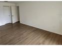 Spacious bedroom with hardwood floors and neutral walls at 6008 Village Cir # Ge, Orlando, FL 32822