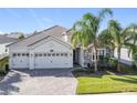 Two-story house with three-car garage and stone accents at 1490 Olympic Club Blvd, Champions Gate, FL 33896