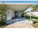 Covered carport with concrete slab and storage area at 2816 Paine Ln, Orlando, FL 32826
