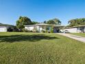Charming ranch home with a large grassy yard and driveway at 2816 Paine Ln, Orlando, FL 32826