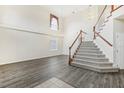 Two-story foyer with open staircase and hardwood floors at 6526 Lake Pembroke Pl, Orlando, FL 32829
