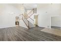 High ceiling living room with an open staircase and hardwood floors at 6526 Lake Pembroke Pl, Orlando, FL 32829