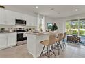 Modern kitchen with stainless steel appliances and an island with seating at 704 Preston Cove Dr, St Cloud, FL 34771