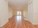 View of living room from entry way, laminate flooring, sliding glass door to balcony at 934 Lake Destiny Rd # D, Altamonte Springs, FL 32714