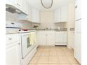 Kitchen with white cabinets, tiled floors, and modern appliances at 934 Lake Destiny Rd # D, Altamonte Springs, FL 32714