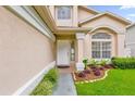 Front entrance with white door and landscaping at 14646 Brightwell Ct, Orlando, FL 32824