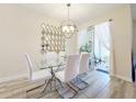 Dining room with glass table, white chairs, and access to a patio at 3053 Gatsby St, Kissimmee, FL 34746