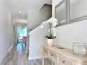 Bright and airy entryway with a console table and mirrors at 3053 Gatsby St, Kissimmee, FL 34746
