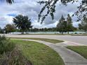 Scenic community view with a pond, lush landscaping, and walking paths at 9066 Rhodes St, Kissimmee, FL 34747