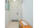 Bright entryway with tile floors, white door, and console table at 121 Palermo St, Davenport, FL 33897