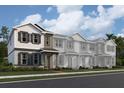 Two-story townhome with gray siding, stone accents, and a front porch at 1340 Lumpini St, Saint Cloud, FL 34771