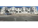 Row of new townhouses with gray and white exterior at 1360 Lumpini St, St Cloud, FL 34771