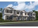Three-story townhome units with gray siding at 1384 Lumpini St, St Cloud, FL 34771
