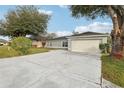 Single-story house with a driveway and mature trees at 359 Marquee Dr, Kissimmee, FL 34758