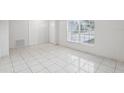 Open concept living room with tile floors and large window at 359 Marquee Dr, Kissimmee, FL 34758