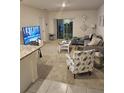 Living room with grey sectional sofa and sliding glass doors at 1295 Berry Ln, Davenport, FL 33837