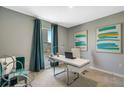 Home office with a desk, chair, and teal curtains at 1683 Three Bars Rd, Kissimmee, FL 34744