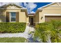 Front entrance of a single-story home with landscaping and a walkway at 2815 Shelburne Way, Saint Cloud, FL 34772