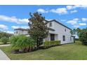 Two story house with stone accents and lush landscaping at 5353 White Blossom Cir, Saint Cloud, FL 34771