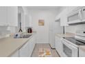 White kitchen with appliances and light countertops at 8100 Princess Palm Ln # 305, Kissimmee, FL 34747