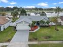 Single-story house with a lake view and well-maintained lawn at 2315 Whispering Maple Dr, Orlando, FL 32837