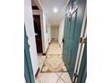Condo hallway with tiled floor and kitchen peek at 4407 S Semoran Blvd # 2, Orlando, FL 32822