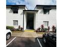 Condo building entrance with stairs and landscaping at 4407 S Semoran Blvd # 2, Orlando, FL 32822