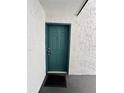 Condo entryway with teal door and welcome mat at 4407 S Semoran Blvd # 2, Orlando, FL 32822
