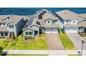 Two story house with solar panels and a view of the lake at 18357 Mowry Ct, Orlando, FL 32827
