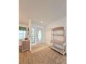 Bright entryway with a neutral color palette and a decorative shelf at 6604 Scenic Point Se Dr, Winter Haven, FL 33884