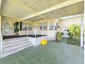 Covered front porch with steps leading to the entrance of the home at 6604 Scenic Point Se Dr, Winter Haven, FL 33884