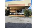 Main entrance to the building with a covered awning, fountain, and parking area at 7900 S Orange Blossom Trl # 2097, Orlando, FL 32809