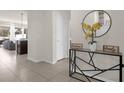 Bright entryway with tile floors, console table, and mirror at 2412 Dubai St, Kissimmee, FL 34747