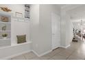 Light and airy entryway with built-in bench and storage at 2412 Dubai St, Kissimmee, FL 34747