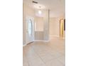 Bright and spacious entryway with tile flooring and an arched doorway at 864 Stonechase Ln, Lake Mary, FL 32746