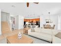 Open floor plan living room with kitchen and staircase views at 2610 Calistoga Ave, Kissimmee, FL 34741
