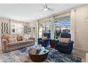 Comfortable living room featuring a beige sofa, blue armchairs, and access to a lanai at 3894 Lana Ave, Davenport, FL 33897