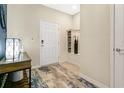 Bright and airy entryway with a built-in storage bench, tile flooring, and a white door at 3894 Lana Ave, Davenport, FL 33897